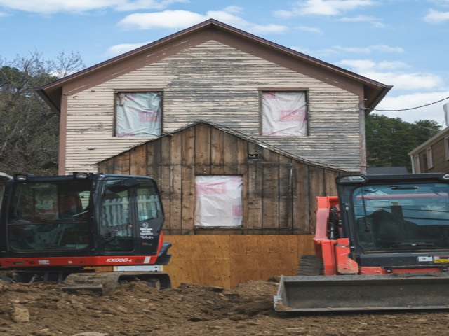 A 5 tonne class excavator working beside a house
